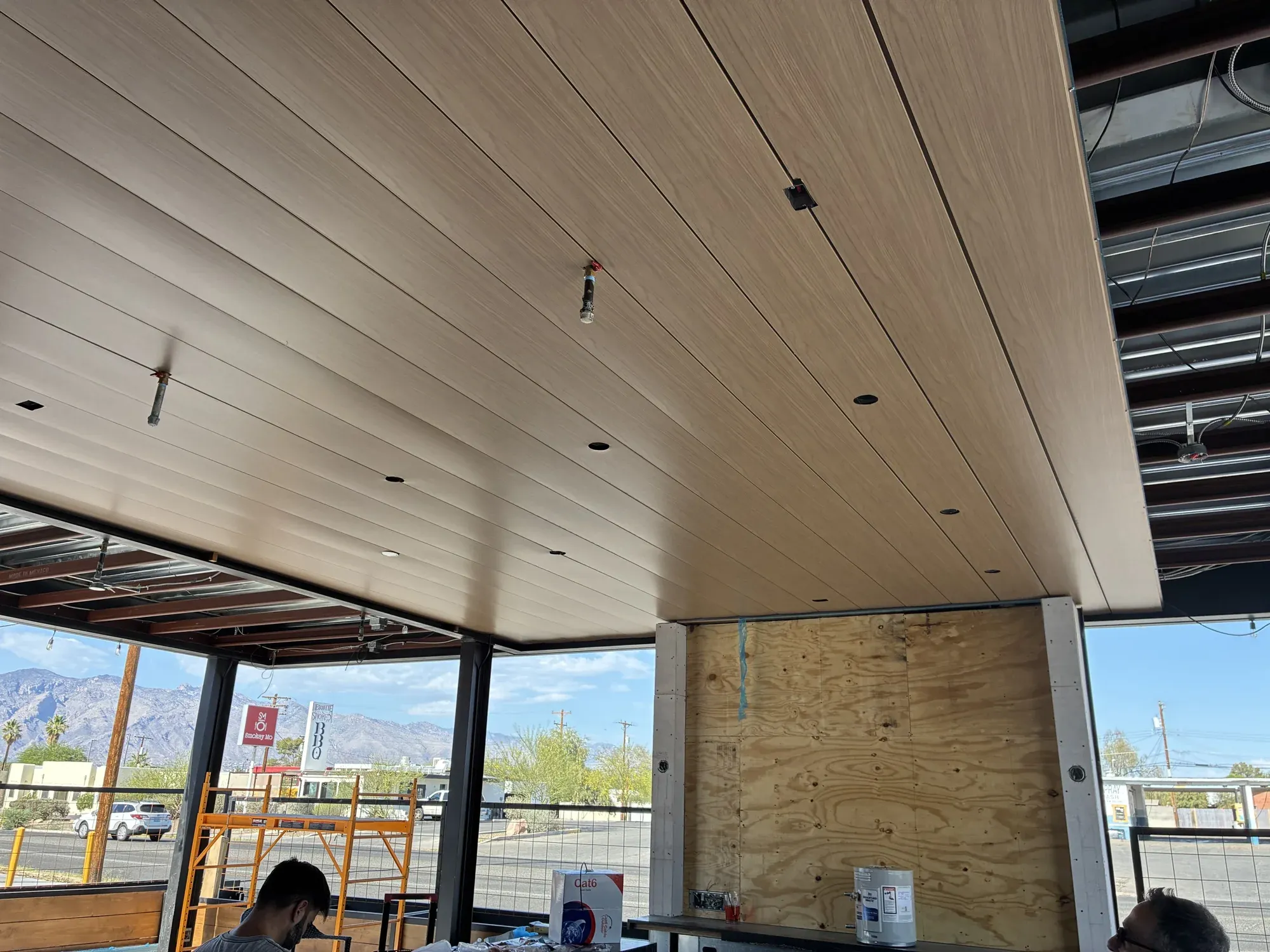 Close view of wood-grain metal ceiling panels